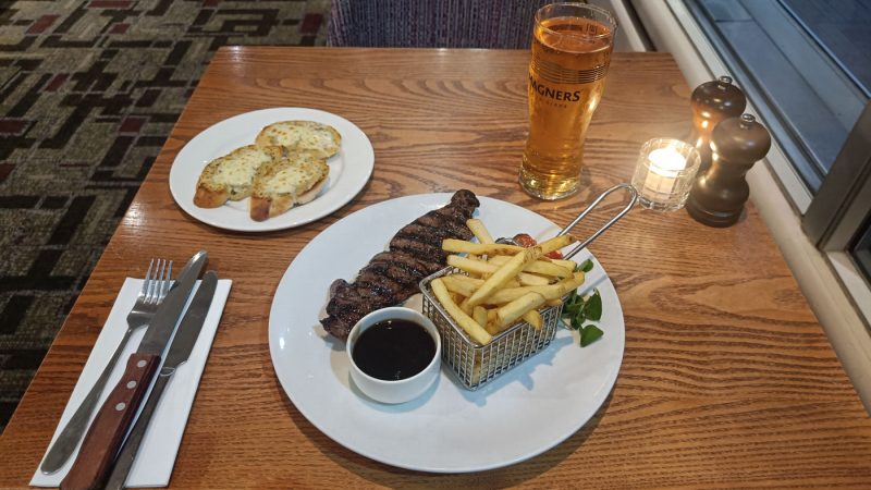 Steak, chips, and garlic bread at my airport hotel